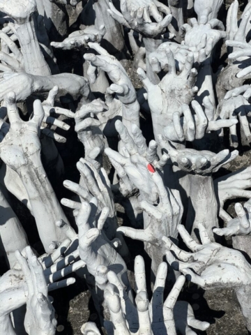 White Temple hands symbolize unrestrained desire